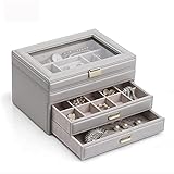 Die Schmuckorganisation zeigt Schmuckaufbewahrungsboxen und -kästen mit transparenten Glasdeckeln, unterschiedlichen Halskettenfächern, Armbändern, Ringen, Schlösser, Schlüssel, und Ohrringe. Schmuck